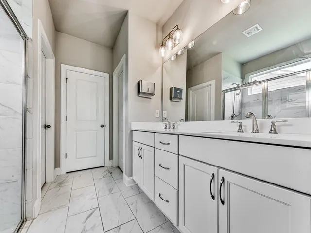 a spacious bathroom with a double vanity sink mirror and