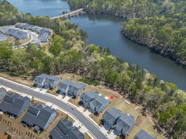 an aerial view of a house with a lake view