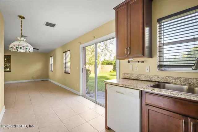 a kitchen with granite countertop a sink and a window