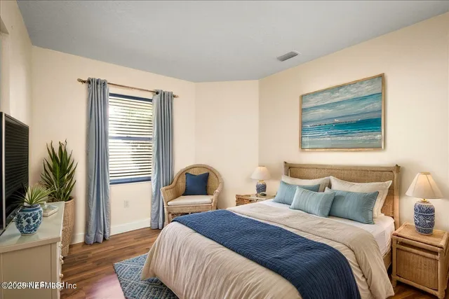 a bedroom with bed and a large window