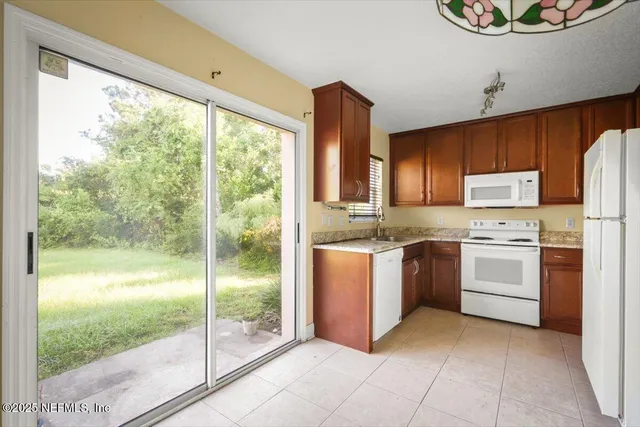 a kitchen with a refrigerator and a stove