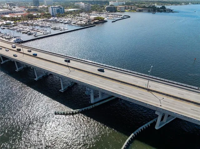 a living room with furniture a rug and kitchen view