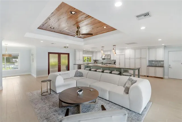 a living room with stainless steel appliances kitchen island furniture and a view of kitchen