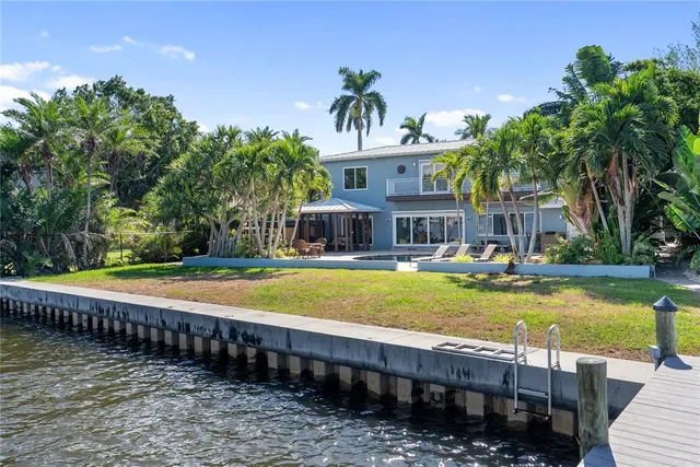 a view of a house with swimming pool and a yard
