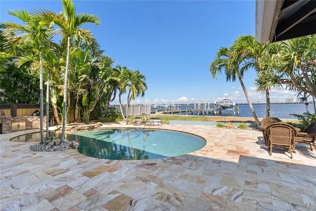 a swimming pool with outdoor seating and yard