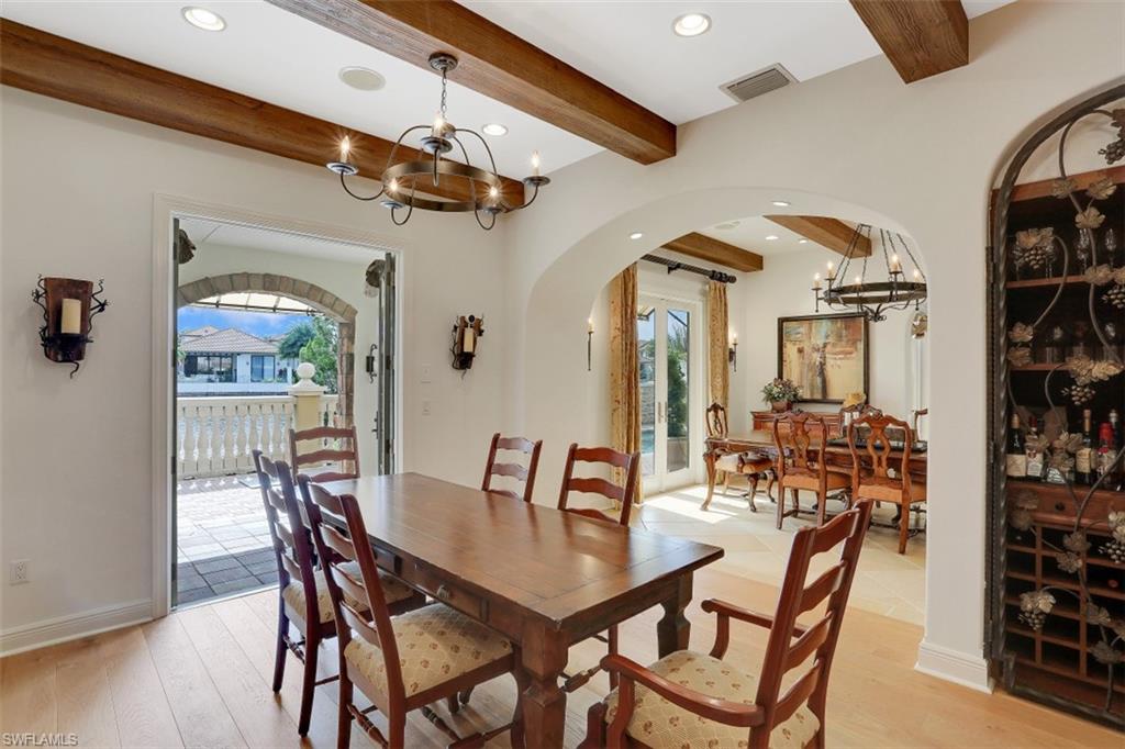 16649 Toscana Circle, Unit 806 Naples, FL 34110 - Photo 11 of 35 a view of a dining room with furniture and wooden floor