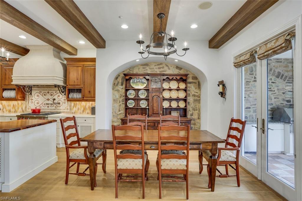 16649 Toscana Circle, Unit 806 Naples, FL 34110 - Photo 12 of 35 a view of a dining room with furniture and a chandelier