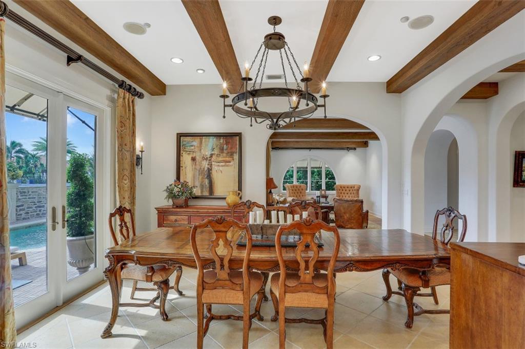 16649 Toscana Circle, Unit 806 Naples, FL 34110 - Photo 13 of 35 a view of a dining room with furniture and chandelier