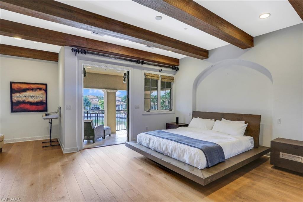 16649 Toscana Circle, Unit 806 Naples, FL 34110 - Photo 19 of 35 a bedroom with a bed and a large window