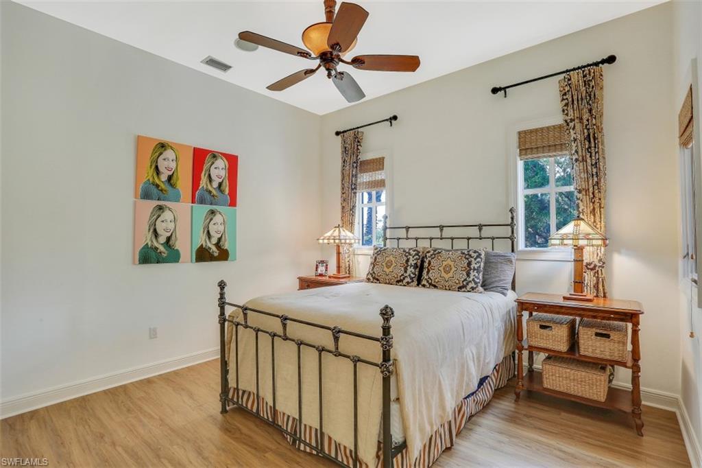 16649 Toscana Circle, Unit 806 Naples, FL 34110 - Photo 22 of 35 a bedroom with a bed a dresser and paintings on the wall