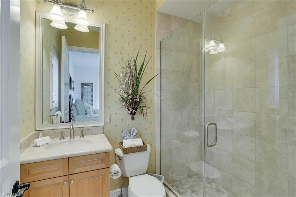 16649 Toscana Circle, Unit 806 Naples, FL 34110 - Photo 26 of 35 a bathroom with a sink toilet a mirror and shower