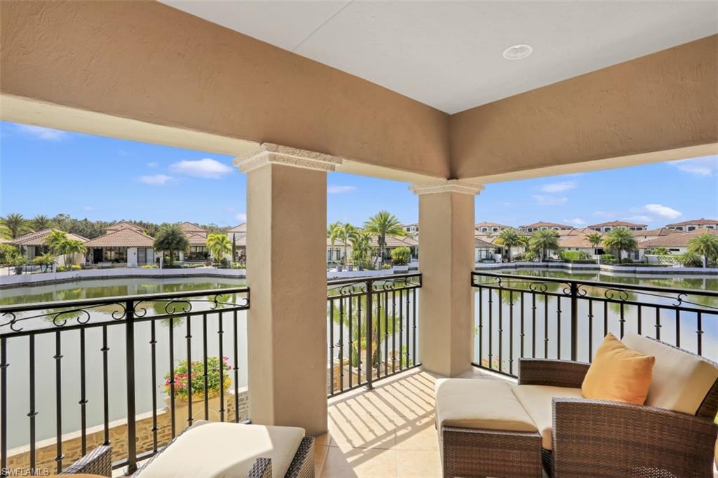 16649 Toscana Circle, Unit 806 Naples, FL 34110 - Photo 28 of 35 a balcony with wooden floor table and chairs