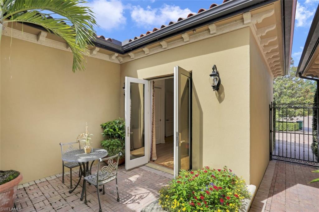 16649 Toscana Circle, Unit 806 Naples, FL 34110 - Photo 30 of 35 a view of a porch with furniture and floor to ceiling window
