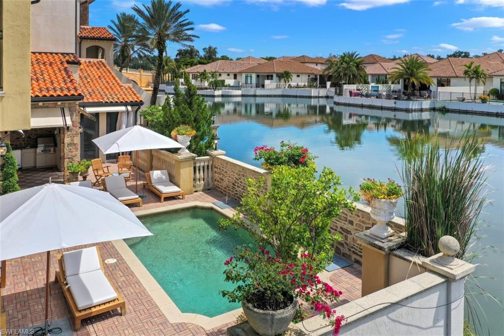 16649 Toscana Circle, Unit 806 Naples, FL 34110 - Photo 5 of 35 a view of a swimming pool and lounge chair in the patio