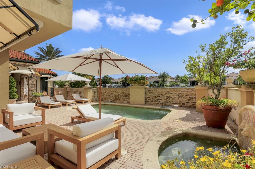16649 Toscana Circle, Unit 806 Naples, FL 34110 - Photo 6 of 35 a view of a swimming pool with a patio