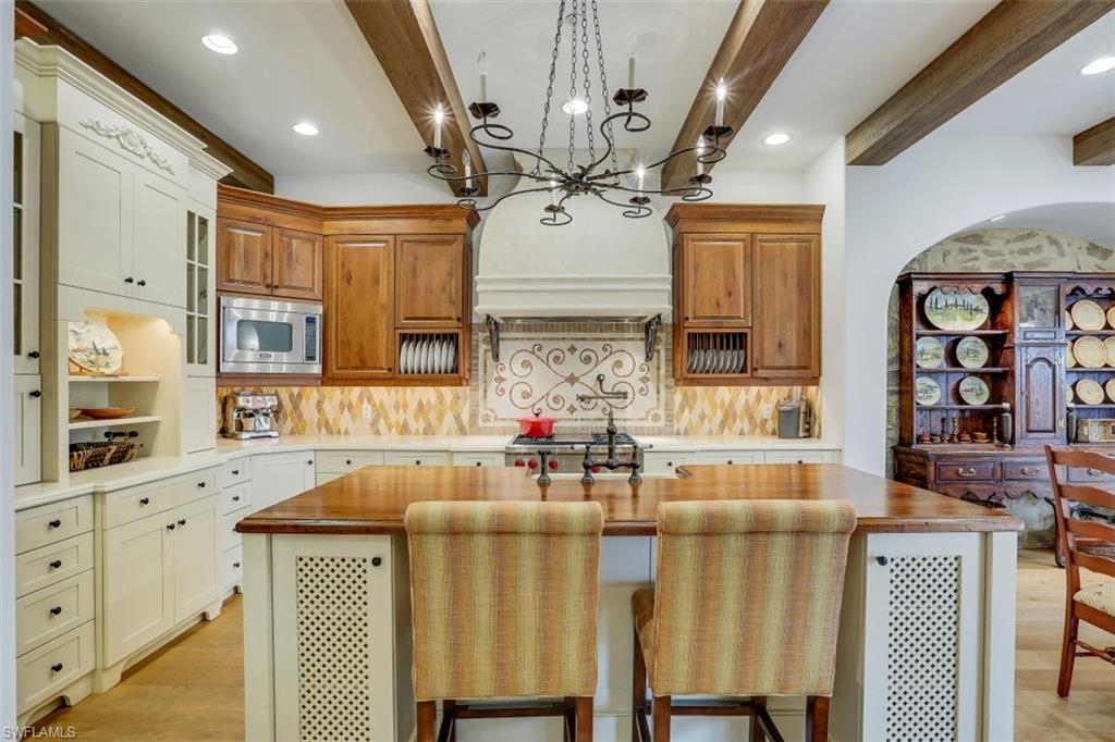 16649 Toscana Circle, Unit 806 Naples, FL 34110 - Photo 8 of 35 a kitchen with stainless steel appliances granite countertop a sink and cabinets