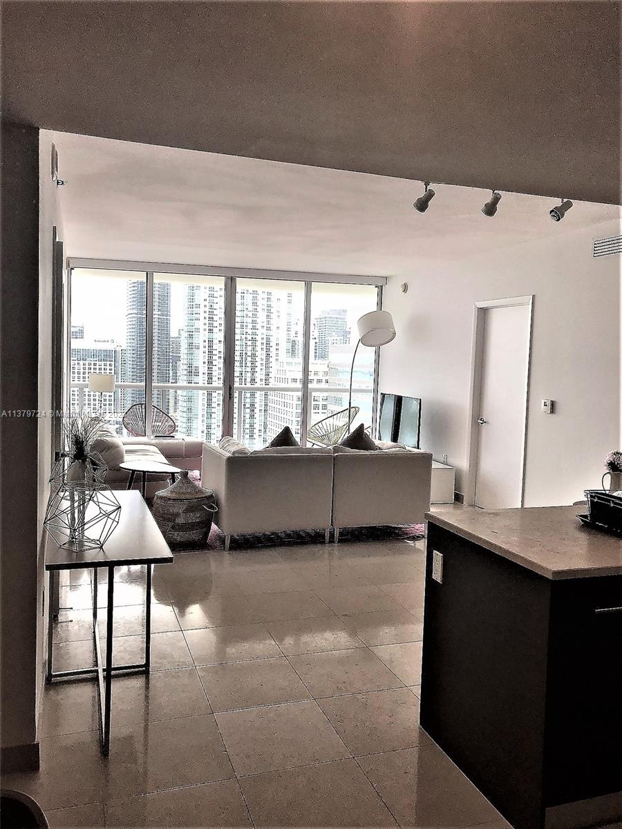 495 Brickell Avenue, Unit 3603 Miami, FL 33131 - Photo 13 of 48 a living room with furniture and a large window