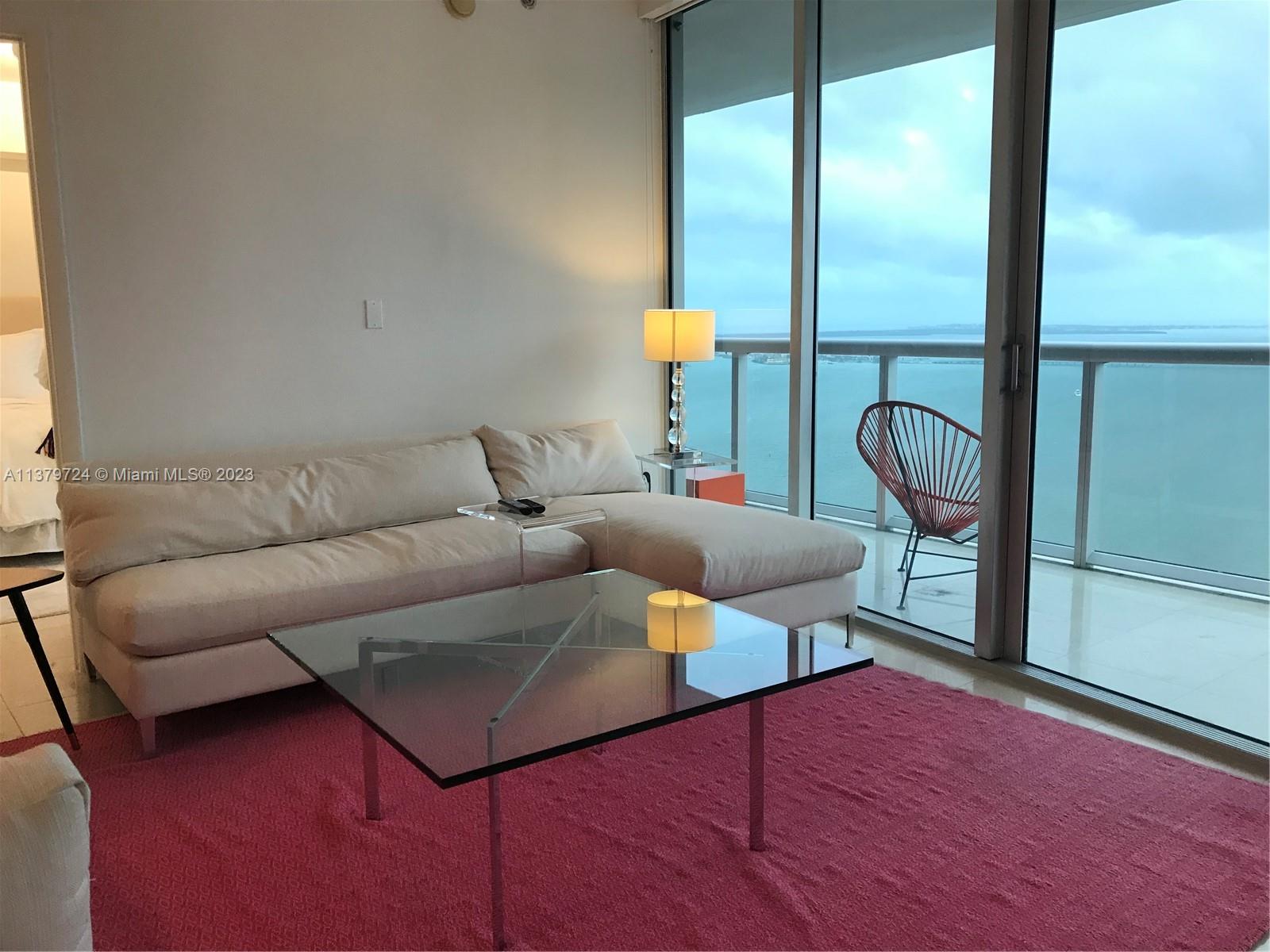 495 Brickell Avenue, Unit 3603 Miami, FL 33131 - Photo 15 of 48 a living room with furniture and a floor to ceiling window