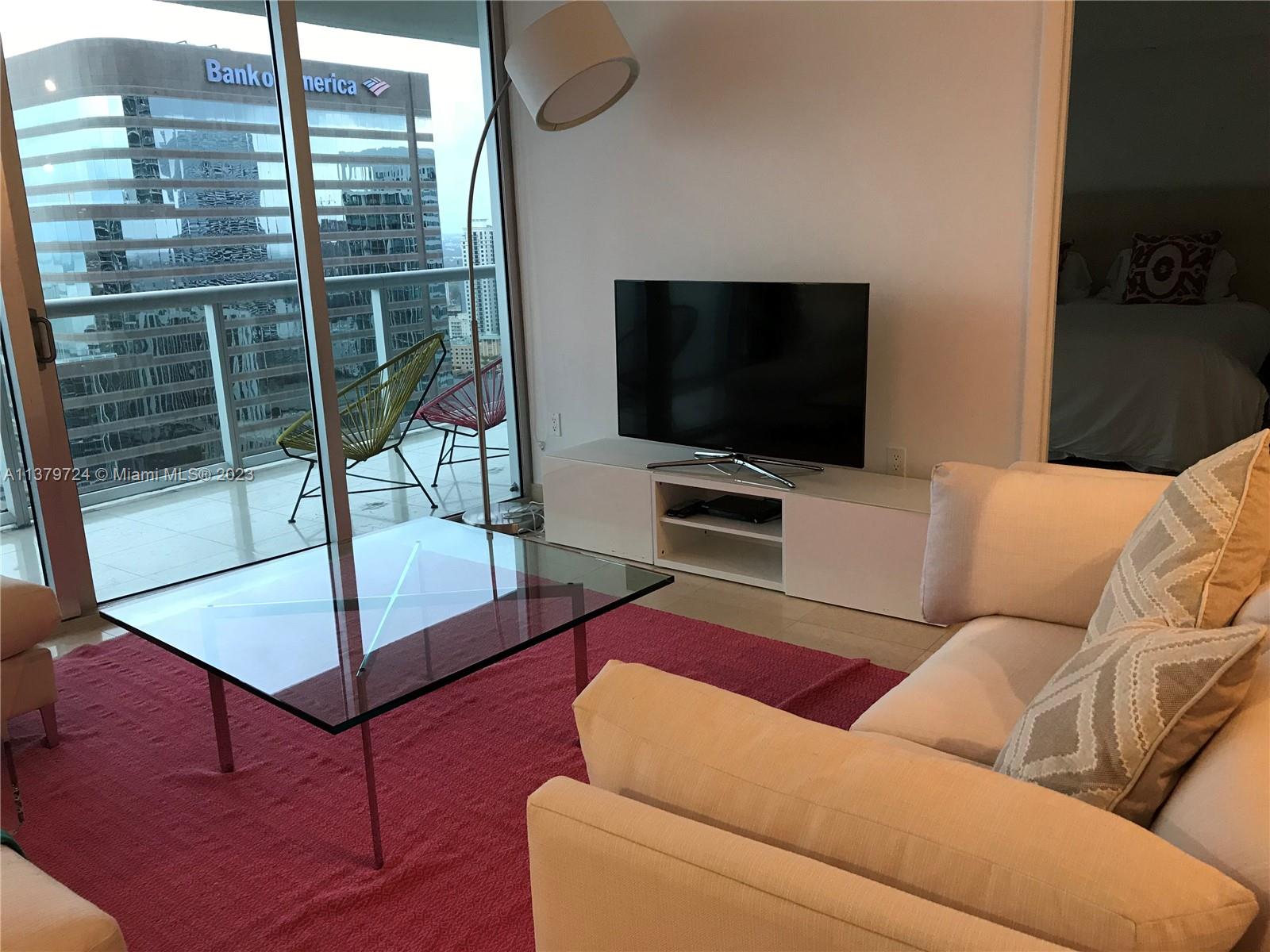 495 Brickell Avenue, Unit 3603 Miami, FL 33131 - Photo 18 of 48 a living room with furniture and a flat screen tv