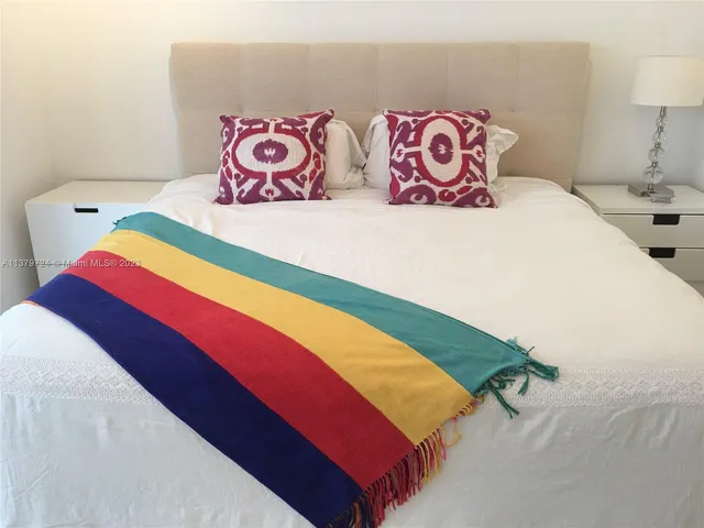 a bedroom with a bed and lamp