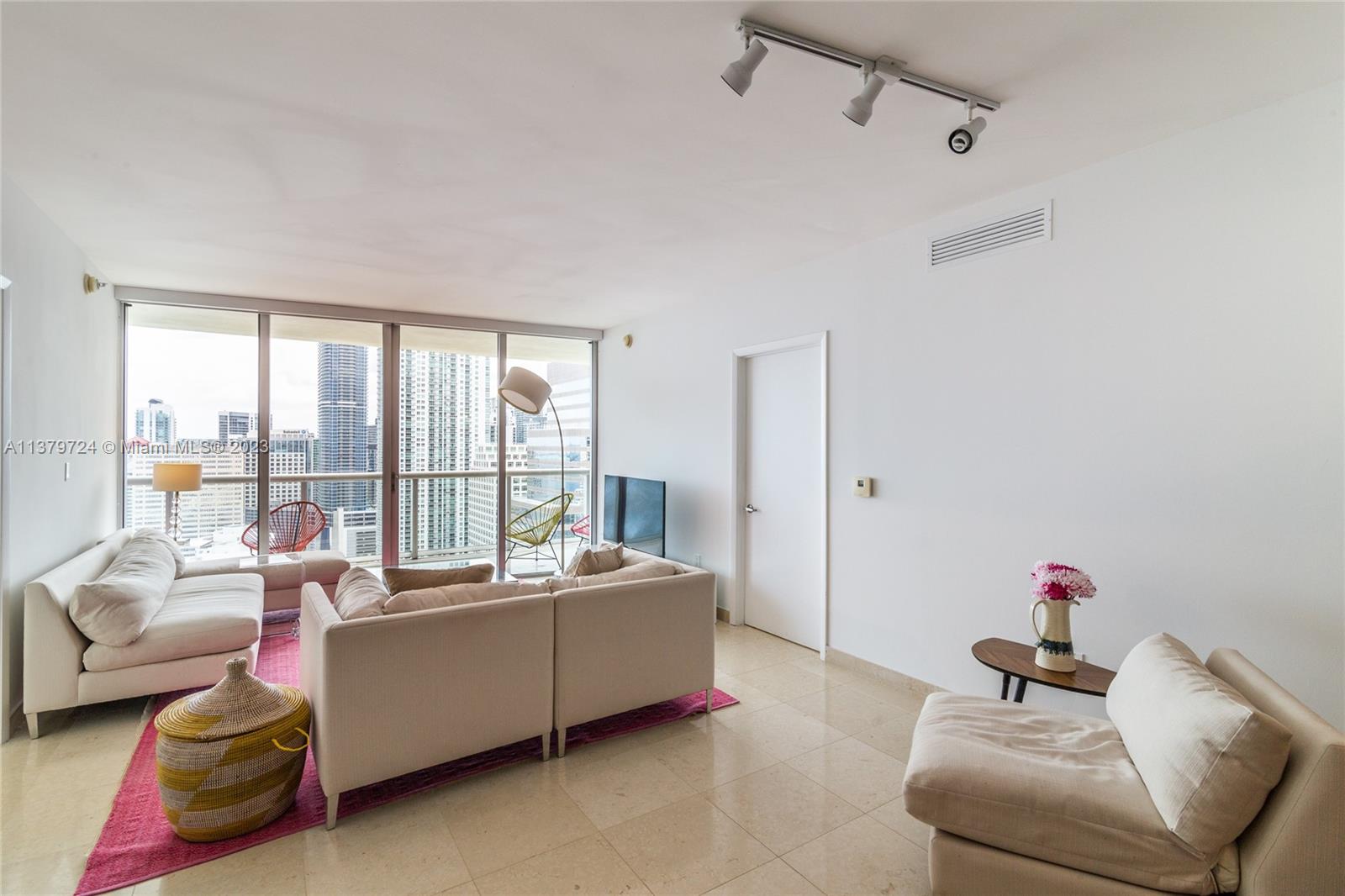 495 Brickell Avenue, Unit 3603 Miami, FL 33131 - Photo 4 of 48 a living room with furniture and a floor to ceiling window