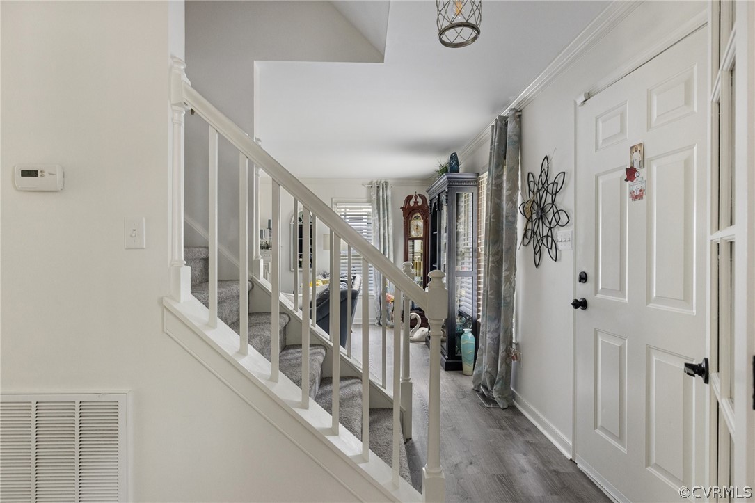 5603 Standing Oak Road Midlothian, VA 23112 - Photo 13 of 39 a view of staircase with lots of frames on wall and a window