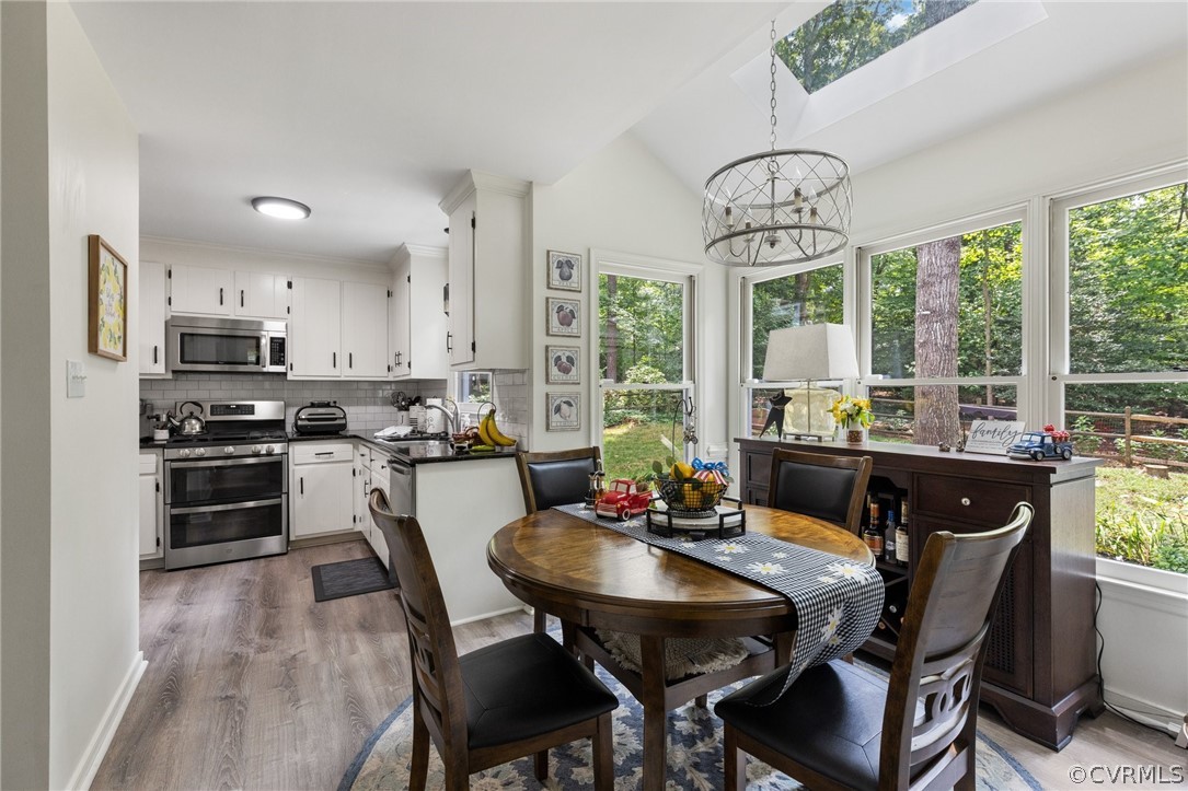 5603 Standing Oak Road Midlothian, VA 23112 - Photo 14 of 39 a view of a dining room with furniture window and outside view