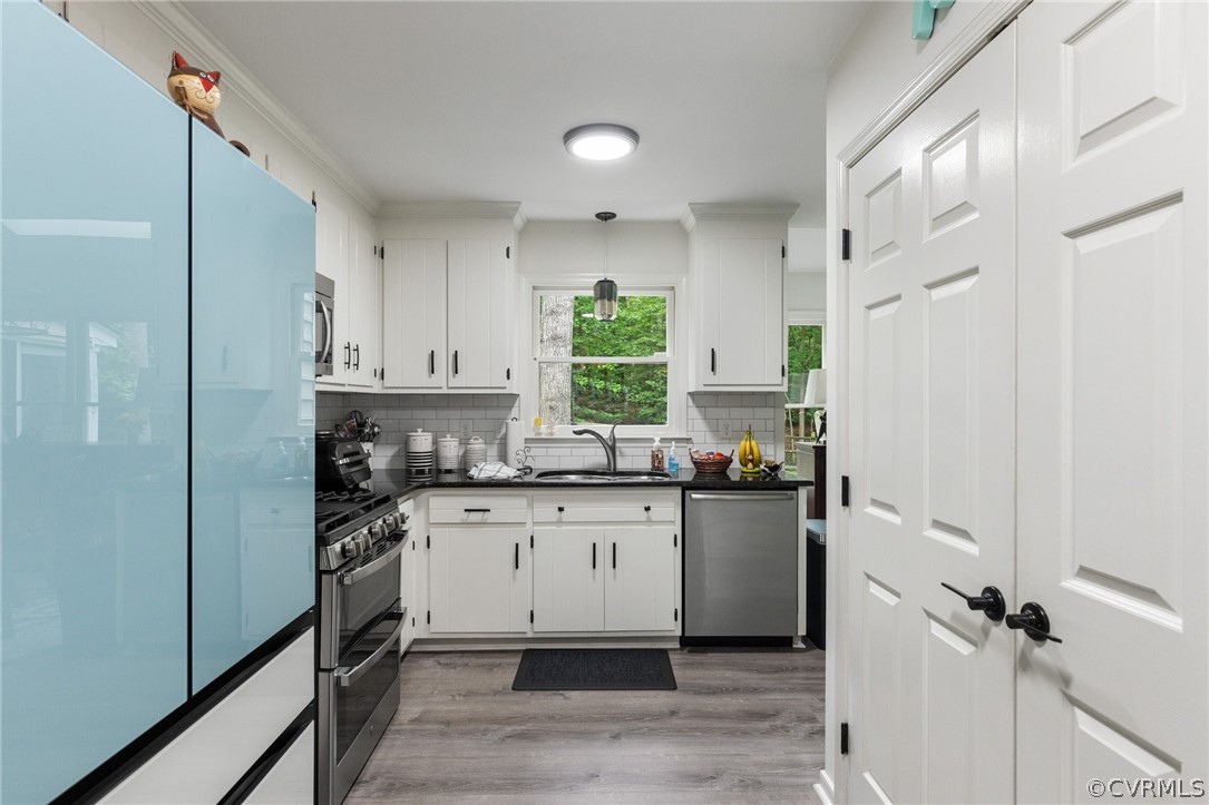 5603 Standing Oak Road Midlothian, VA 23112 - Photo 16 of 39 a kitchen with a sink stainless steel appliances and white cabinets