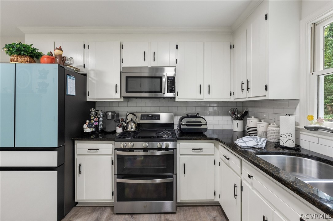 5603 Standing Oak Road Midlothian, VA 23112 - Photo 18 of 39 a kitchen with granite countertop white cabinets and stainless steel appliances