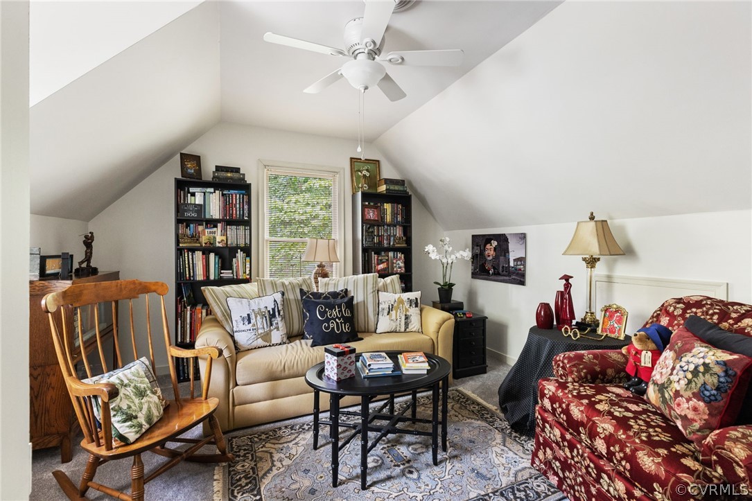 5603 Standing Oak Road Midlothian, VA 23112 - Photo 23 of 39 a living room with furniture a rug and a bookshelf