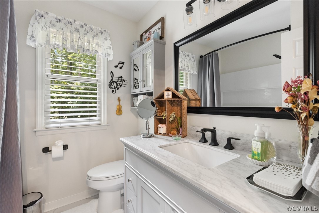 5603 Standing Oak Road Midlothian, VA 23112 - Photo 25 of 39 a bathroom with a sink a toilet and a mirror
