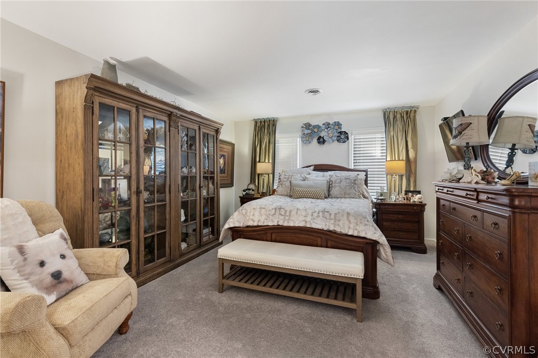 5603 Standing Oak Road Midlothian, VA 23112 - Photo 27 of 39 a spacious bedroom with a bed and a walk in closet