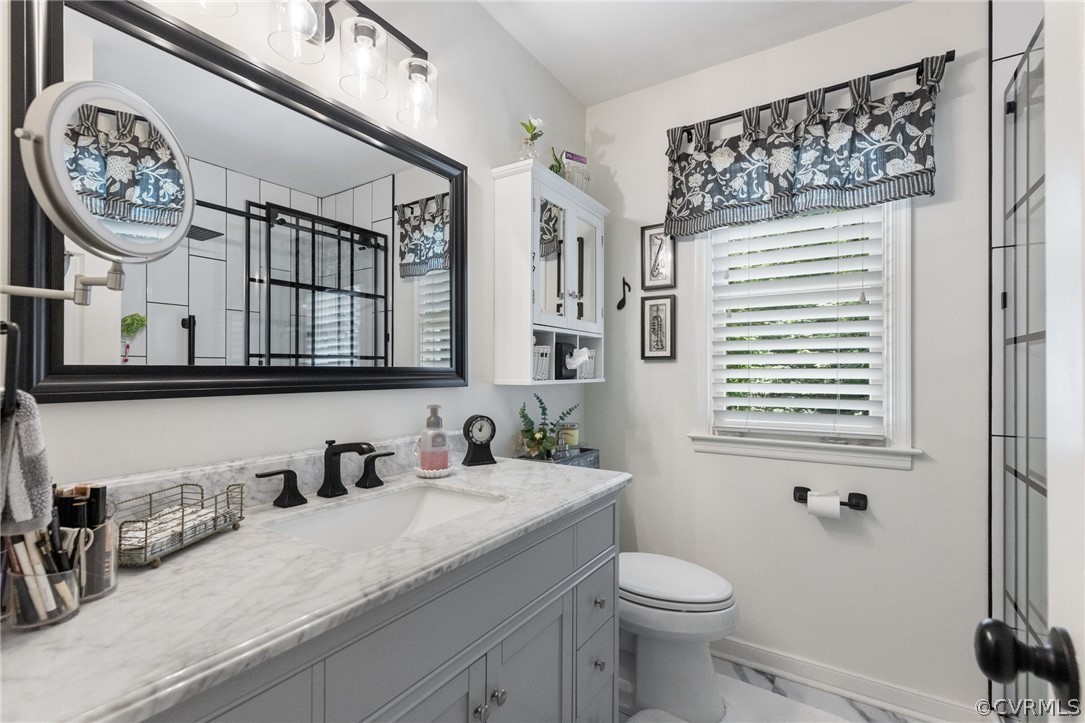 5603 Standing Oak Road Midlothian, VA 23112 - Photo 28 of 39 a bathroom with a granite countertop sink mirror vanity and toilet