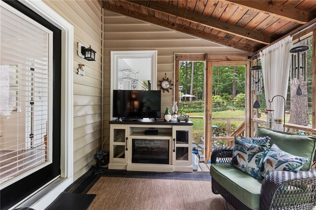 5603 Standing Oak Road Midlothian, VA 23112 - Photo 30 of 39 a living room with furniture a flat screen tv and a floor to ceiling window