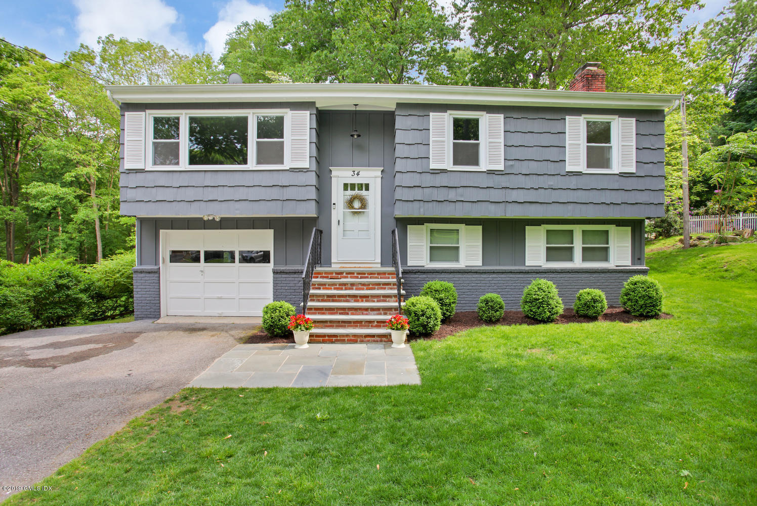 34 Dandy Drive Cos Cob, CT 06807 - Photo 2 of 20 a front view of a house with garden
