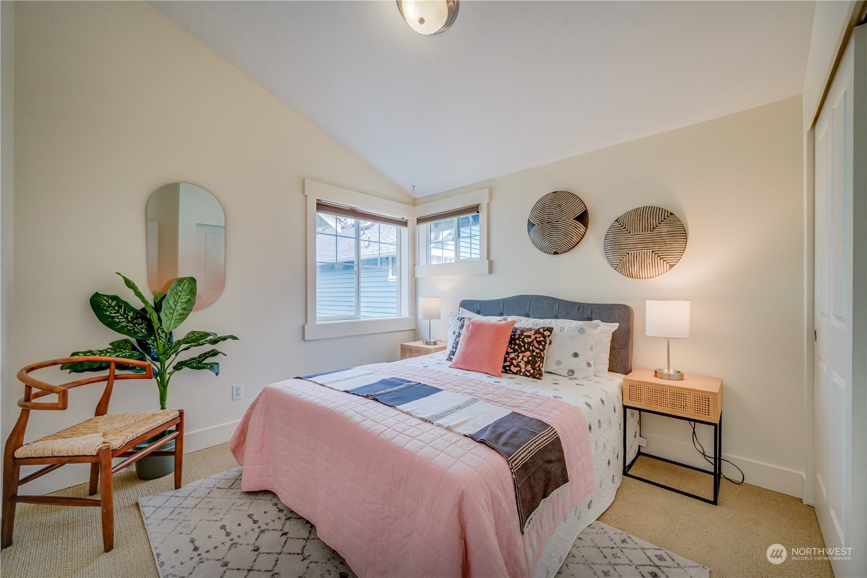 508 North 46th Street, Unit B Seattle, WA 98103 - Photo 16 of 30 a bedroom with a bed a dresser with potted plants on wooden floor