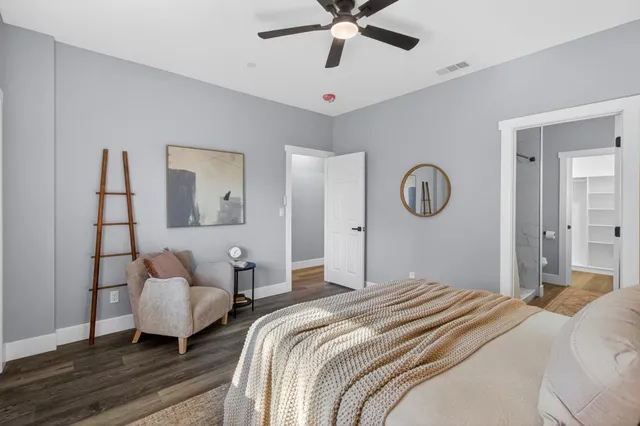 a bedroom with bed and a chandelier
