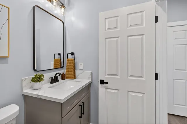 a bathroom with a sink vanity and a mirror
