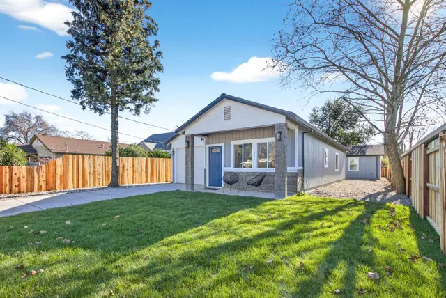 a house view with a sitting space and garden