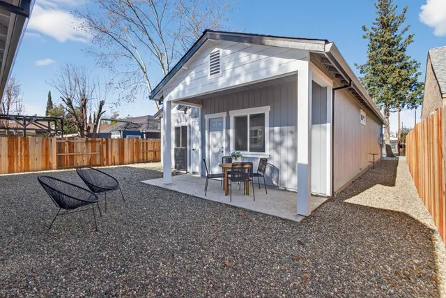 a view of a house with backyard porch and furniture