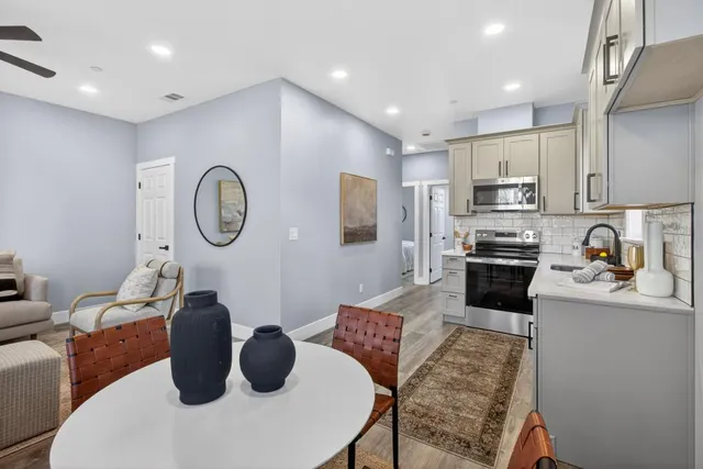 a kitchen with a refrigerator a stove a sink and a refrigerator with wooden floor