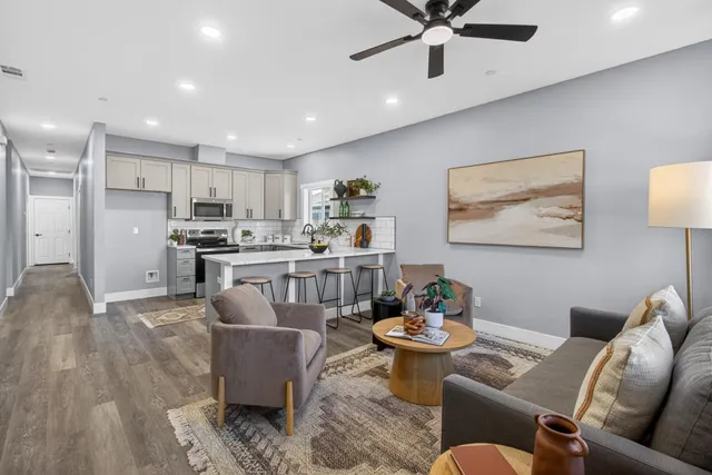 a living room with furniture and kitchen view