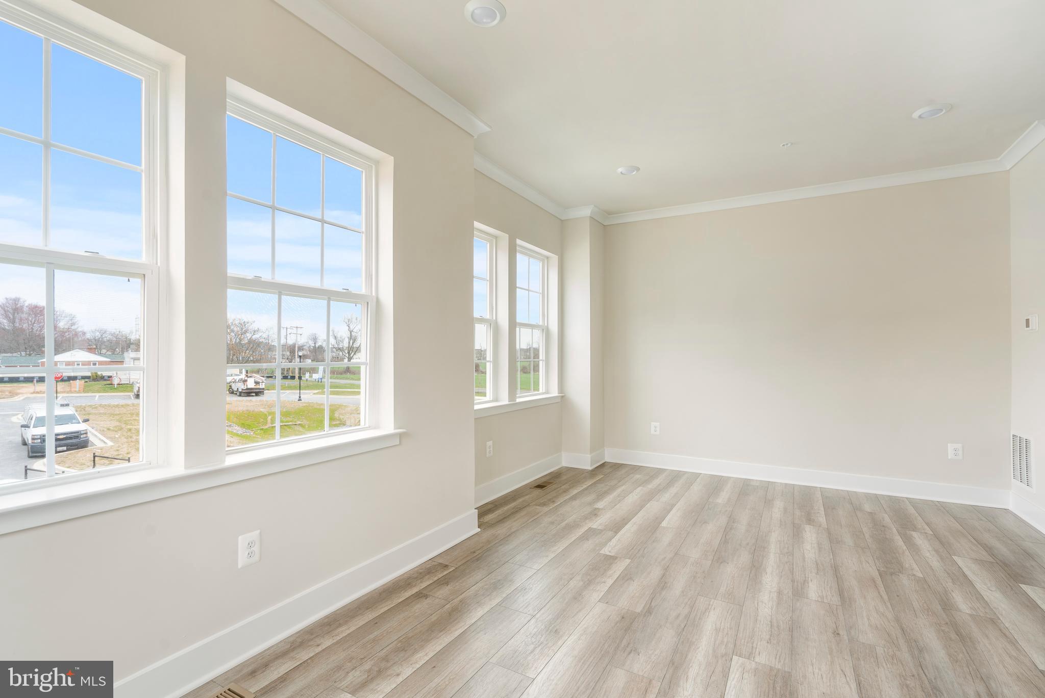 1425 Clingmans Dome Drive Frederick, MD 21702 - Photo 15 of 46 a view of an empty room with wooden floor and a window