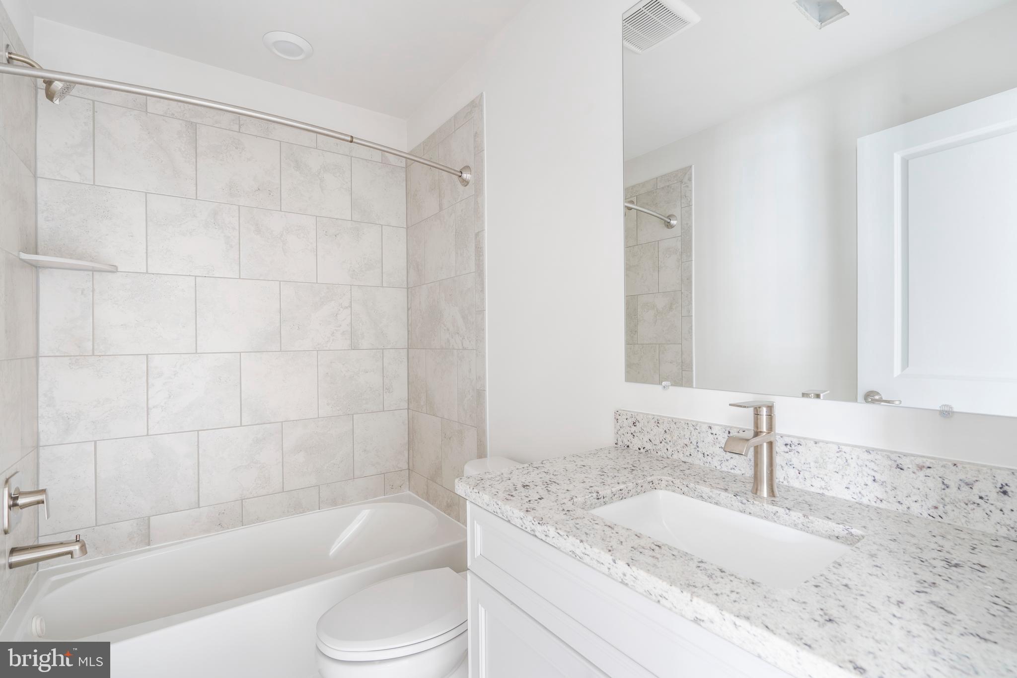 1425 Clingmans Dome Drive Frederick, MD 21702 - Photo 20 of 46 a bathroom with a granite countertop sink toilet bathtub and shower
