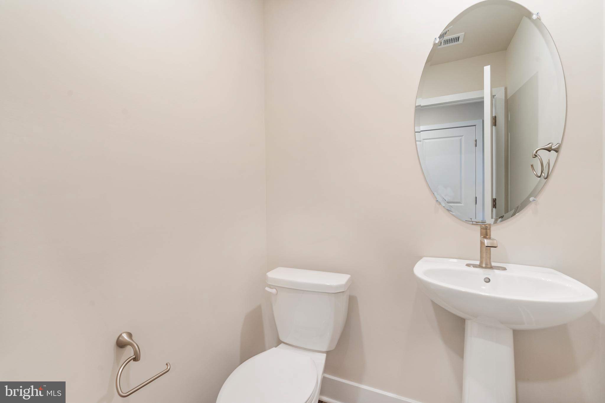 1425 Clingmans Dome Drive Frederick, MD 21702 - Photo 28 of 46 a bathroom with a toilet sink and mirror
