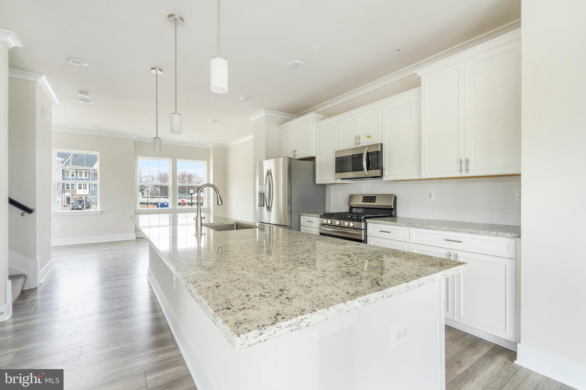 1425 Clingmans Dome Drive Frederick, MD 21702 - Photo 6 of 46 a kitchen with stainless steel appliances granite countertop a sink a stove top oven a counter space and cabinets