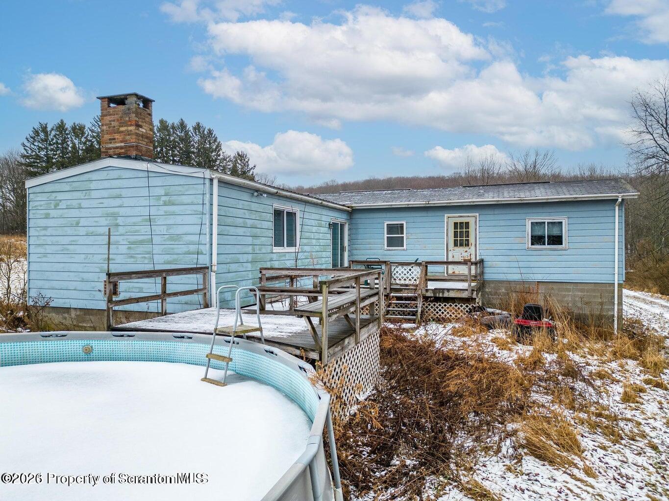 1777 Lamb Road Thompson, PA 18465 - Photo 30 of 31 a backyard of a house with yard and outdoor seating