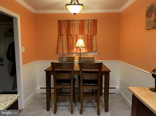 a view of a dining room with furniture and window