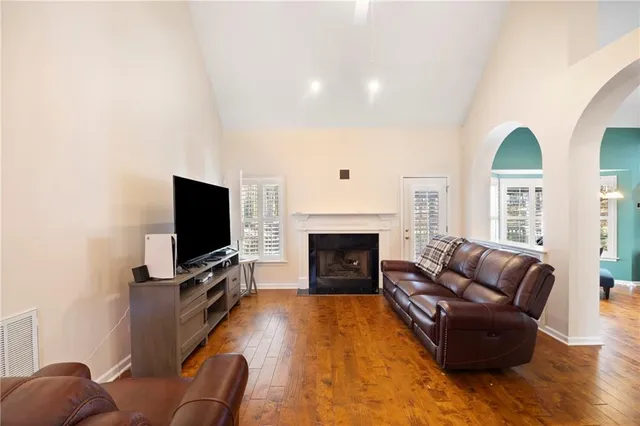 a living room with furniture flat screen tv and a fireplace