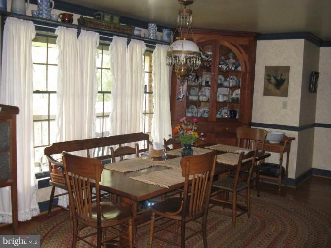 11625 Walnut Point Road Hagerstown, MD 21740 - Photo 11 of 25 a view of a dining room with furniture window and wooden floor